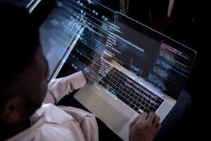 Man coding on his computer